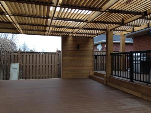 Wood accent walls and louvered wood pergola