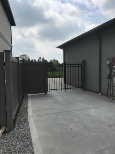 Vinyl fence with double ornamental gates