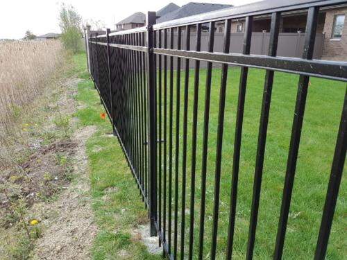 Montage iron fence with bufftech vinyl fence