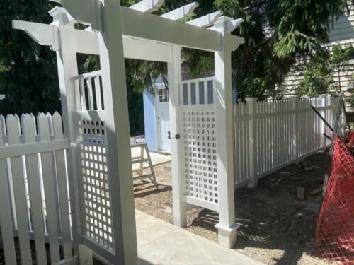 White picket vinyl fence with gate and arbor